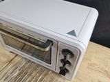a toaster oven sitting on top of a wooden table