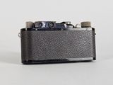 an old camera sitting on top of a table with a white background