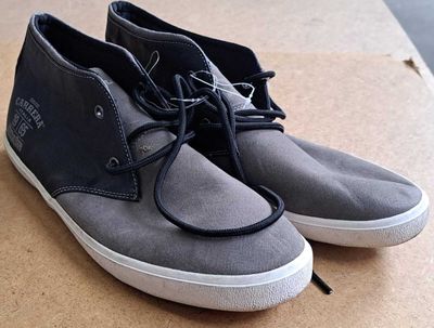 a pair of shoes that are sitting on a cardboard box
