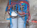 a cart with two cylinders and a hose attached to it