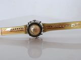 an image of a gold watch with a black face on a white surface