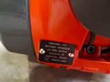 an orange and black vacuum cleaner sitting on top of a cement floor