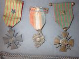 several medals are displayed on a wall with a chain around them