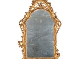 une image d'un miroir encadré d'or sur un mur blanc