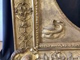 a gold frame with a picture of a duck on it