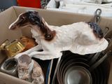 a box with a dog figurine and other items in it