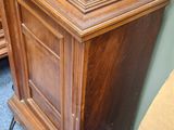 a wooden desk with a clock on top of it