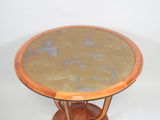 a small round table with a marble top on a wooden stand