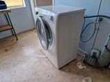 a washer and dryer sitting in a dirty room