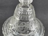 an image of a clear glass bowl with a lid on a black surface