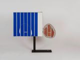 a close up of a blue and white object with a red object on it