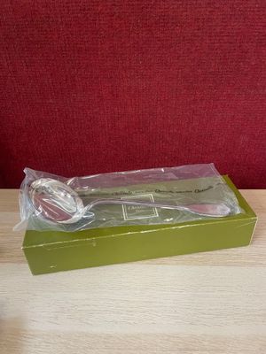 a plastic spoon and fork in a green box on a table