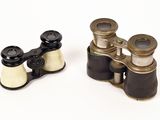 pair of antique binoculars on a white background with a white background