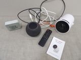 a camera, a remote control, and a box on the floor