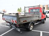a red truck that is parked in a parking lot