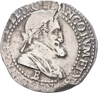 a close up of a coin with a man ' s head on it