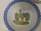 a blue and white bowl with a rooster painted on it