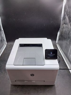 an image of a printer with a cell phone on top of it