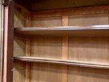 a wooden cabinet with a door open on the inside