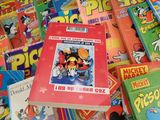 a pile of children ' s books on a table