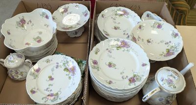many plates and cups in a box on the table