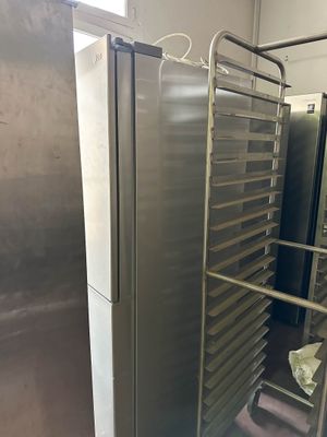 many trays of food that are on a rack in the kitchen