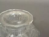 a clear glass jar with a lid sitting on a table