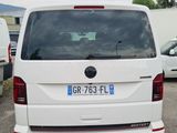 a white van parked in a parking lot with other cars
