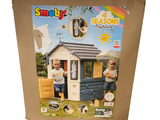 a cardboard box with a picture of a child outside of a house