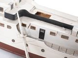 a small model of a boat on a white surface