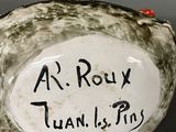 a white and black vase with writing on it
