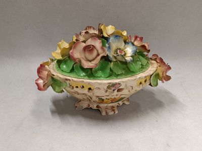 a small bowl with flowers in it on a table
