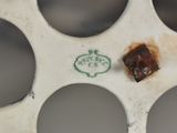 a close up of a piece of metal with holes in it