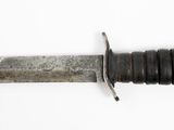 a knife that is laying on top of a white surface