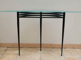 a glass table with a metal frame on it