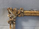 a picture of a gold frame with a flower decoration on it
