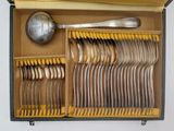 many forks and spoons in a box with a spoon in it