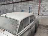 a old car that is sitting in the dirt