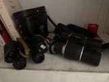 many different types of binoculars sitting on a shelf