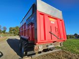 a red dump truck that is parked on the side of the road