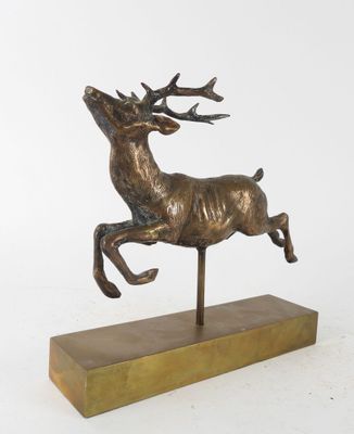 sculpture en bronze représentant un cerf au galop, posée sur un socle en bois