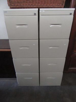 two drawers with baskets on top of them in a room