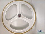 a white plate with a gold rim and a red flower on it