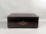 an image of a black box with a gold decoration on it