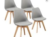 four grey chairs with wooden legs on a white background