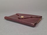 brown leather wallet with a gold clasp on the front