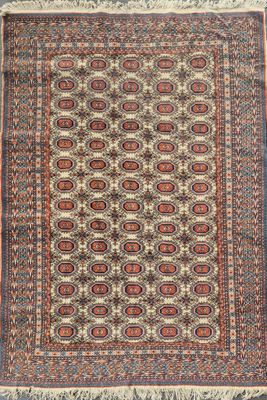 an antique persian rug with a geometric design and fringe fringes