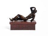 statue of a woman laying down on a marble base
