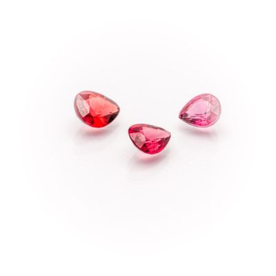 three pink tourmaline gems on a white background