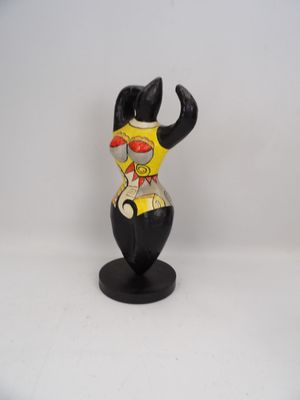a figurine of a cat that is on a stand